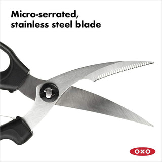 User trimming poultry with OXO Poultry Shears on cutting board

